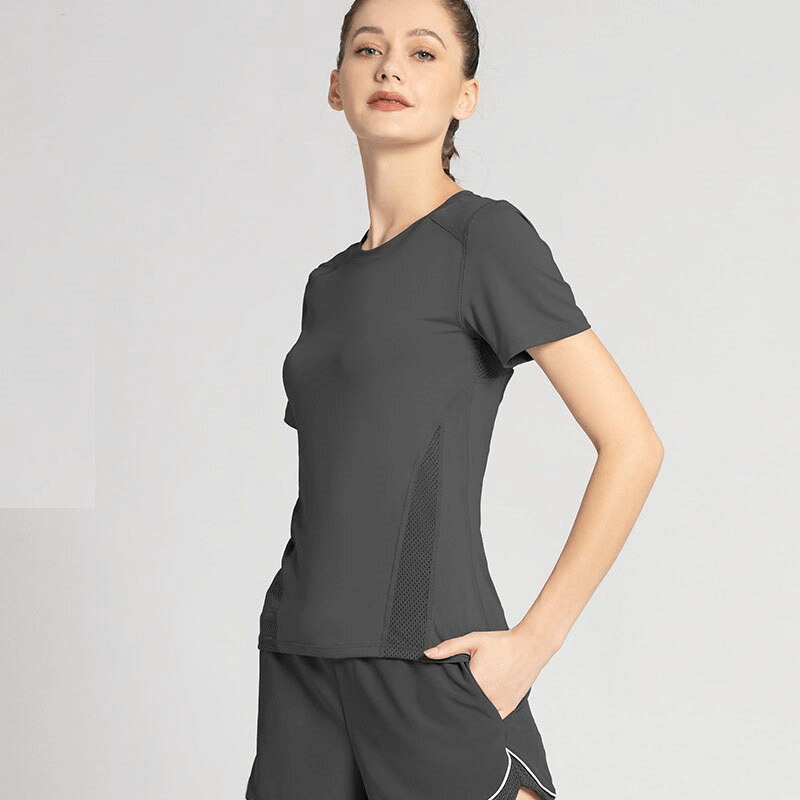 Woman wearing athletic round neck quick dry t-shirt with mesh back, perfect for yoga. Polyester-spandex blend, in stylish black.